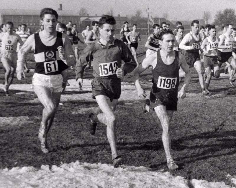 Number 1542 John Wright (Wallasey A.C.) competing in the National Cross Country Championships held at Cambridge on Saturday, March 2nd 1963. Also in the picture are number 61, A. Black (Belgrave Harriers) and number 1198, M. Jackson (Rotherham Harriers and A.C.)