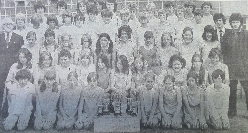 St. George's teams are pictured with Mr W. J. Aldridge (left), chairman of Wallasey Middle Schools Athletics Association and PE staff Miss M. R. Lienau, Mr. C. A. Sanderson and Mr. C. G. Bruce.