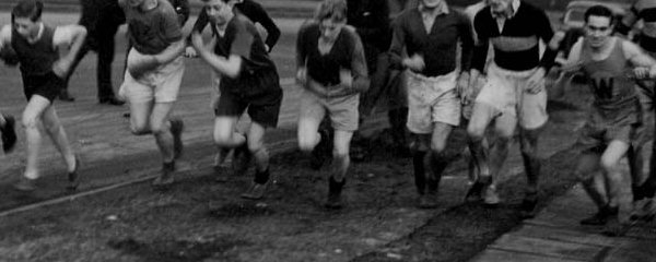 Race on Leasowe Road 1947 Club Christmas Handicap written on the back but Centenary research says 1946 - far left is John Edwards, farthest left spectator is Frank Ledward. Spectator with hat and spectacles is Geroge Mason. Runners on the right are Dennis Dickinson, Tony Dickinson and Denis Kelly